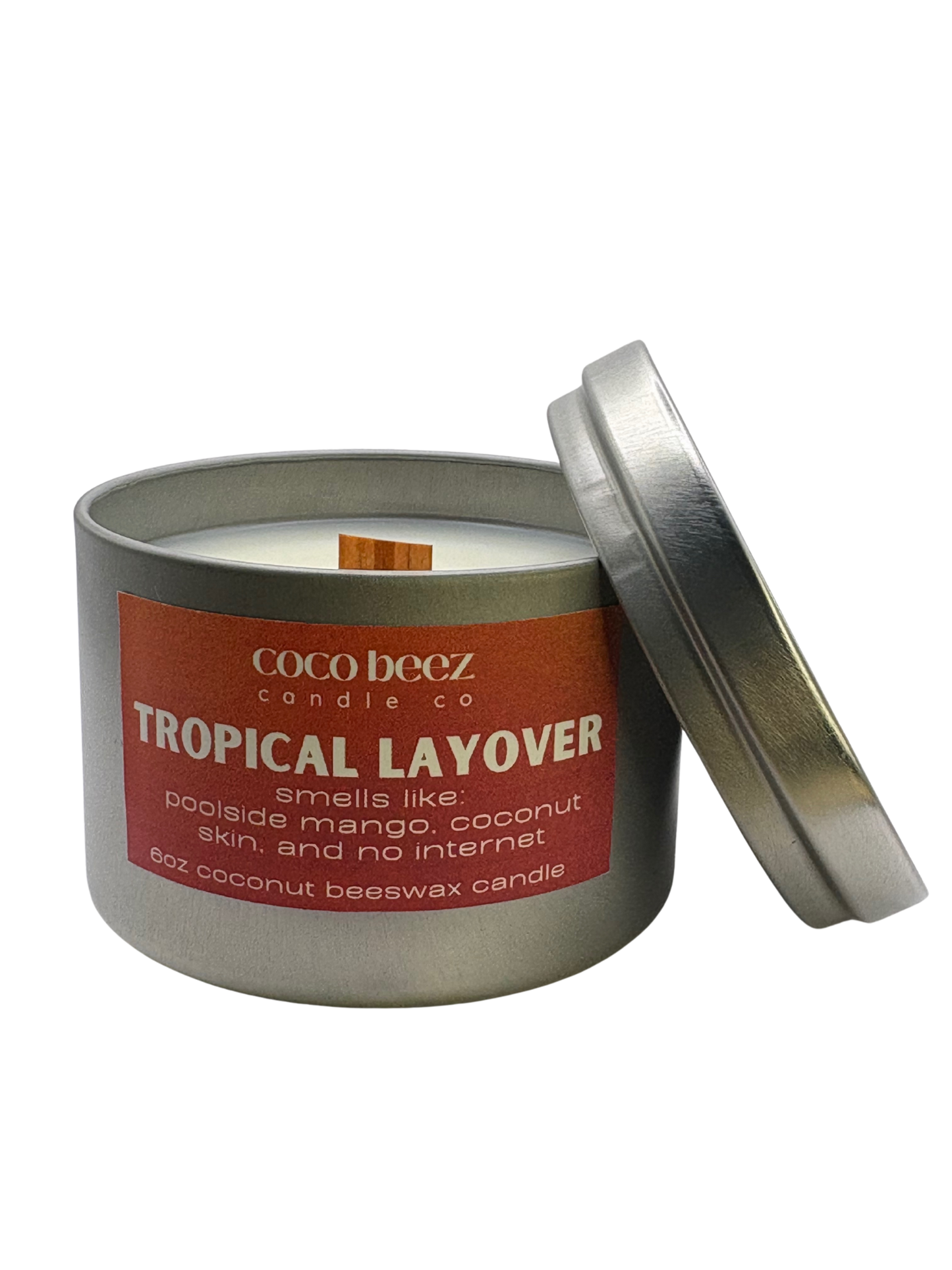 Coco Beez candle in a metal tin labeled 'Tropical Layover'