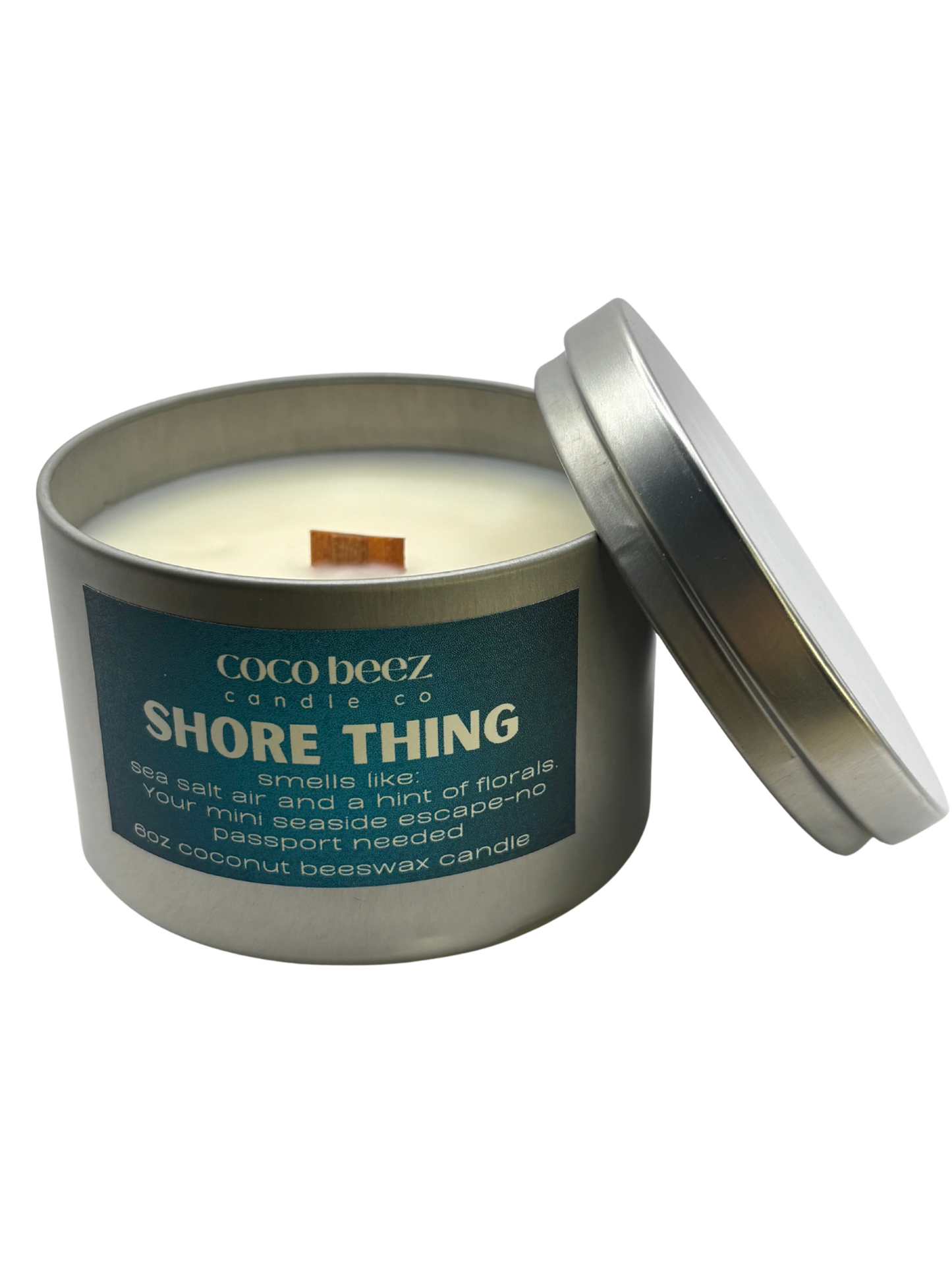 Travel tin candle with Shore Thing on the label