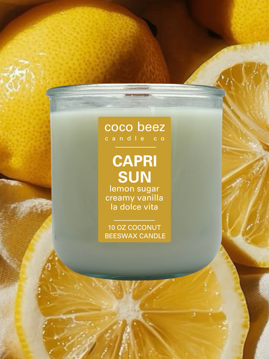 A 10 oz coconut beeswax candle by Coco Beez Candle Co. in a clear glass jar, labeled 'Capri Sun'.