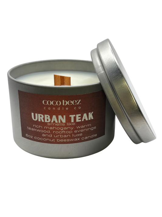 Coco Beez candle in a metal tin labeled 'Urban Teak' 